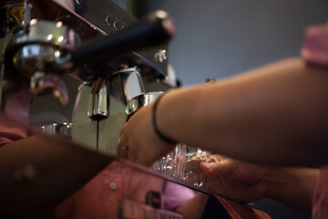 Coffee machine with clear glass under the portafilter ready to use to make espresso.