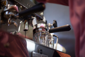 Coffee machine with clear glass under the portafilter ready to use to make espresso.