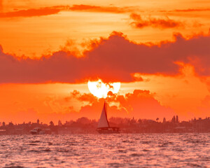 Fototapeta na wymiar Sailboat sailing at sunset beautiful seascape