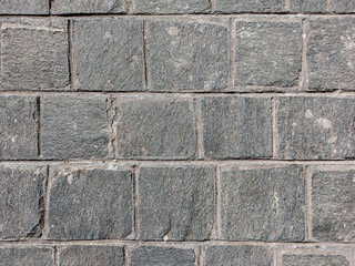 Granite cobblestoned pavement background. Stone pavement texture. Abstract background of cobblestone pavement close-up