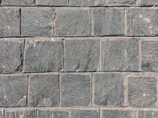 Granite cobblestoned pavement background. Stone pavement texture. Abstract background of cobblestone pavement close-up