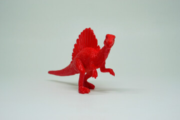 Side view of plastic Spinosaurus dinosaur plastic toy for kids, isolated on a studio lighting...