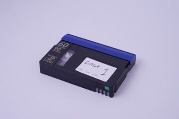 high angle view, Front isometric view of Mini DV video cassette tape isolate on white studio lighting background.
