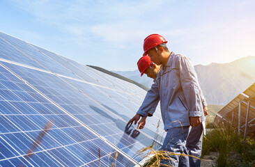 Two asian workers are checking solar photovoltaic outdoors