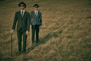 gentlemen in black suits