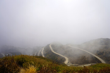 SILK ROUTE ZIG ZAG ROAD IN CLOUDY WEATHER IN SIKKIM