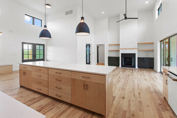 large empty kitchen with black windows and natural finished hardwood flooring