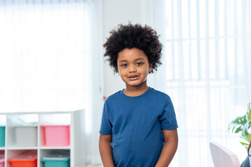 Portrait of  African boy student stand with happiness in class room.