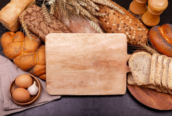 Food and bakery in kitchen concept. Carbohydrate organic food. Homemade cuisine. Different kinds of bread with nutrition whole grains on grey background. Delicious breakfast meal.