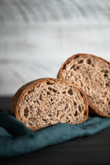 The process of making wheat bread at home. A slice of homemade sourdough bread. The concept of healthy homemade food. Front view.