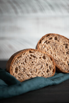 The process of making wheat bread at home. A slice of homemade sourdough bread. The concept of healthy homemade food. Front view.