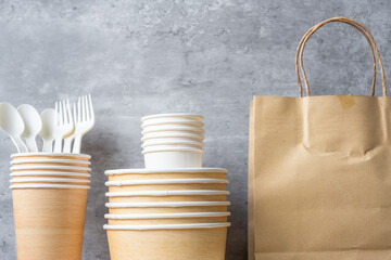 Eco friendly food packaging on table background. natural container: cup, plate, spoon and fork....