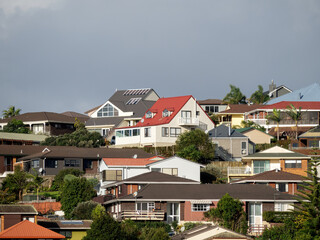 View of suburban houses on hill with colorful roofs