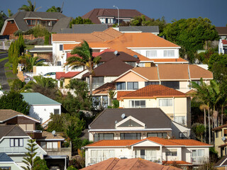 View of suburban houses on hill with colorful roofs