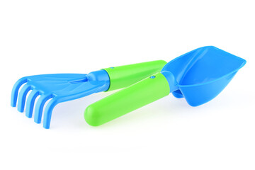 A set of children's toys for playing in the sandbox. Colored rake and shovel made of plastic,...