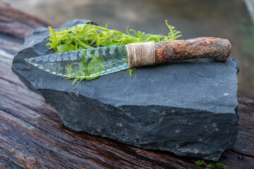 Moonstone handmade sharp knife natural stone age and ferns that ancient humans were able to cook.