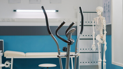 Empty medical office with stationary bicycle used at physical therapy and recovery. Rehabilitation...