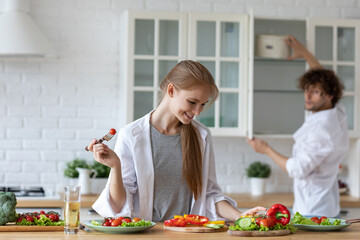 Young beautiful healthy couple preparing a vegetarian breakfast. Spending time together at home, healthy food.