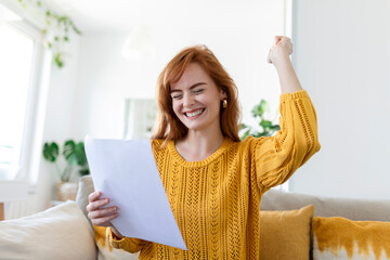 Excited young woman hold paper letter feel euphoric receiving job promotion or tax refund from...