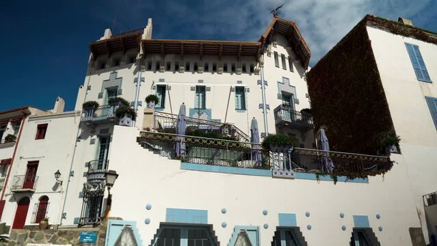 Coastal city of Cadaqu&eacute;s in Spain.
City street with outdoor cafes and restaurants. City center of Cadaqu&eacute;s. Small picturesque town of Cadaqu&eacute;s.  White houses on the waterfront of the resort