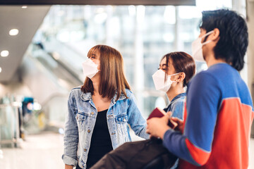 Young friend traveler in quarantine for coronavirus wearing surgical mask face protection with...