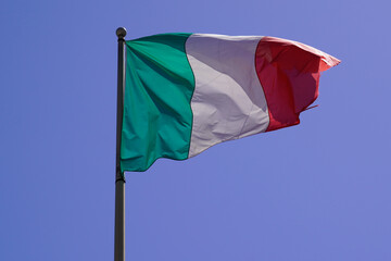 Naklejka na ściany i meble italy flag italian floating in mat with wind on blue sky