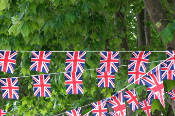 British flags hanging on the streets of London. Union jack flag triangular outside decoration.