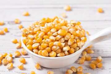 dry corn in small plate on wooden table