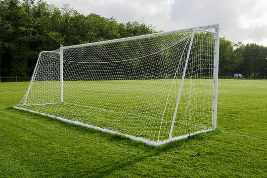 Goal post for soccer or football on a small training pitch. Sport background. Trees in the background. Nobody.