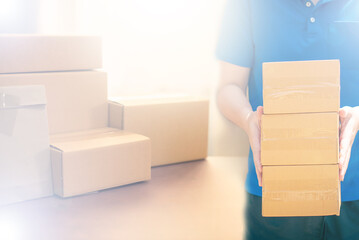 Small business owner packing in the cardbox at workplace. Cropped shot of man preparing a parcel for delivery at online selling business office. Ecommerce drop shipping shipment service concept.