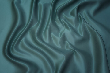 Texture, background, pattern. Texture of green silk fabric. Beautiful emerald green soft silk...