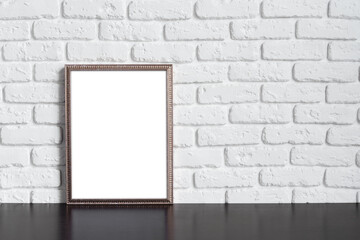 Blank picture frame against brick wall with copy space