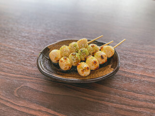 Delicious dangos with soy sauce on plate