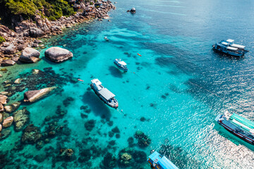 Fototapeta na wymiar Boats and crystal clear waters at the bay dive site in Koh Tao,diving tour boat