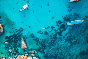 Boats and crystal clear waters at the bay dive site in Koh Tao,diving tour boat