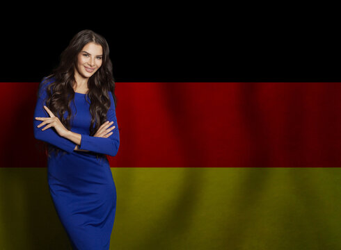 Beautiful brunette woman smiling against German flag background