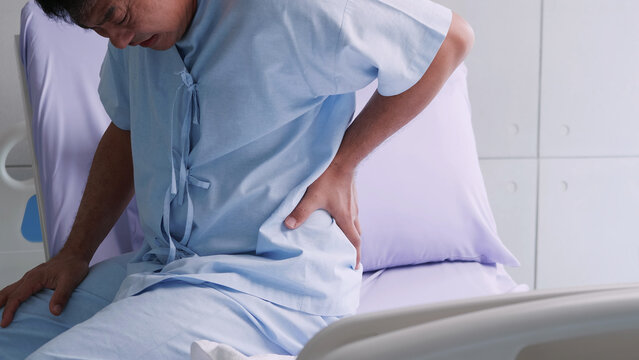 Elderly Asian male patient is hospitalized with back pain.