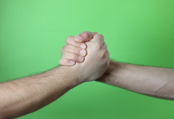 A man making hand signals on green background.