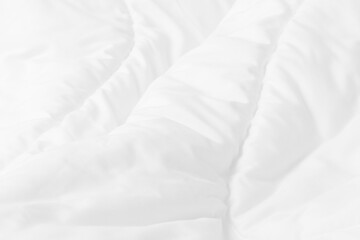 Obraz premium Close up top view of white bedding sheet and wrinkle messy blanket in bedroom after wake up in the morning.