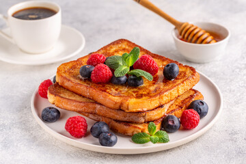French toast with blueberries, raspberries, maple syrup