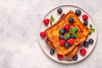 French toast with blueberries, raspberries, maple syrup