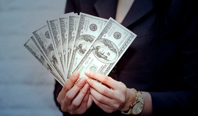 Businesswoman hand with dollar banknote which she is show of money and exchanging money an expenses while could be used for anything from business image