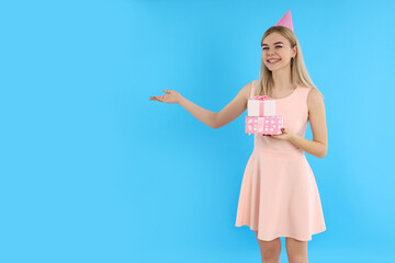 Concept of Happy Birthday with attractive girl on blue background