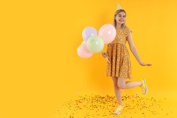 Concept of Happy Birthday with attractive girl on yellow background