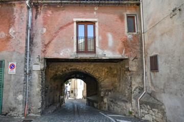 Fototapeta na wymiar A narrow street between the old houses of Teggiano, a medieval village in the mountains of Salerno province, Italy.
