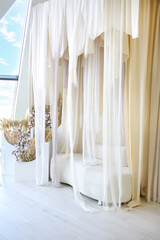 Sofa milky color and transparent curtains. Romantic setting. Modern home. Penthouses. Interior concept