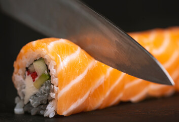 Cook hands making sushi roll closeup photo