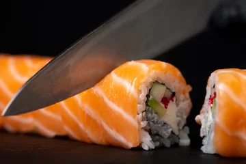 Fotobehang Cook hands making sushi roll closeup photo © vigenmnoyan