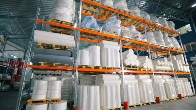 Lots of big rolls of spunbond. Warehouse with rolls of nonwovens. Large warehouse in the nonwovens factory. industrial interior