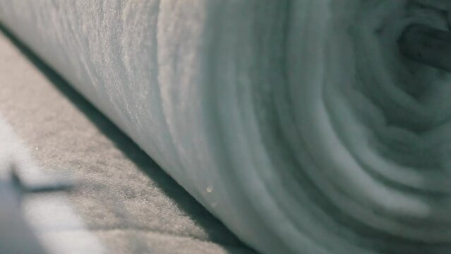 Production of non-cane materials close-up. Factory for the production of synthetic winterizer. Syntepon manufacturing process